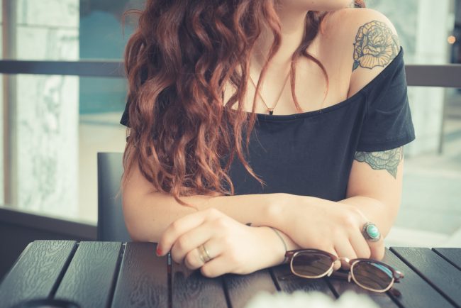 What does a tattoo cost? Young tattooed woman.